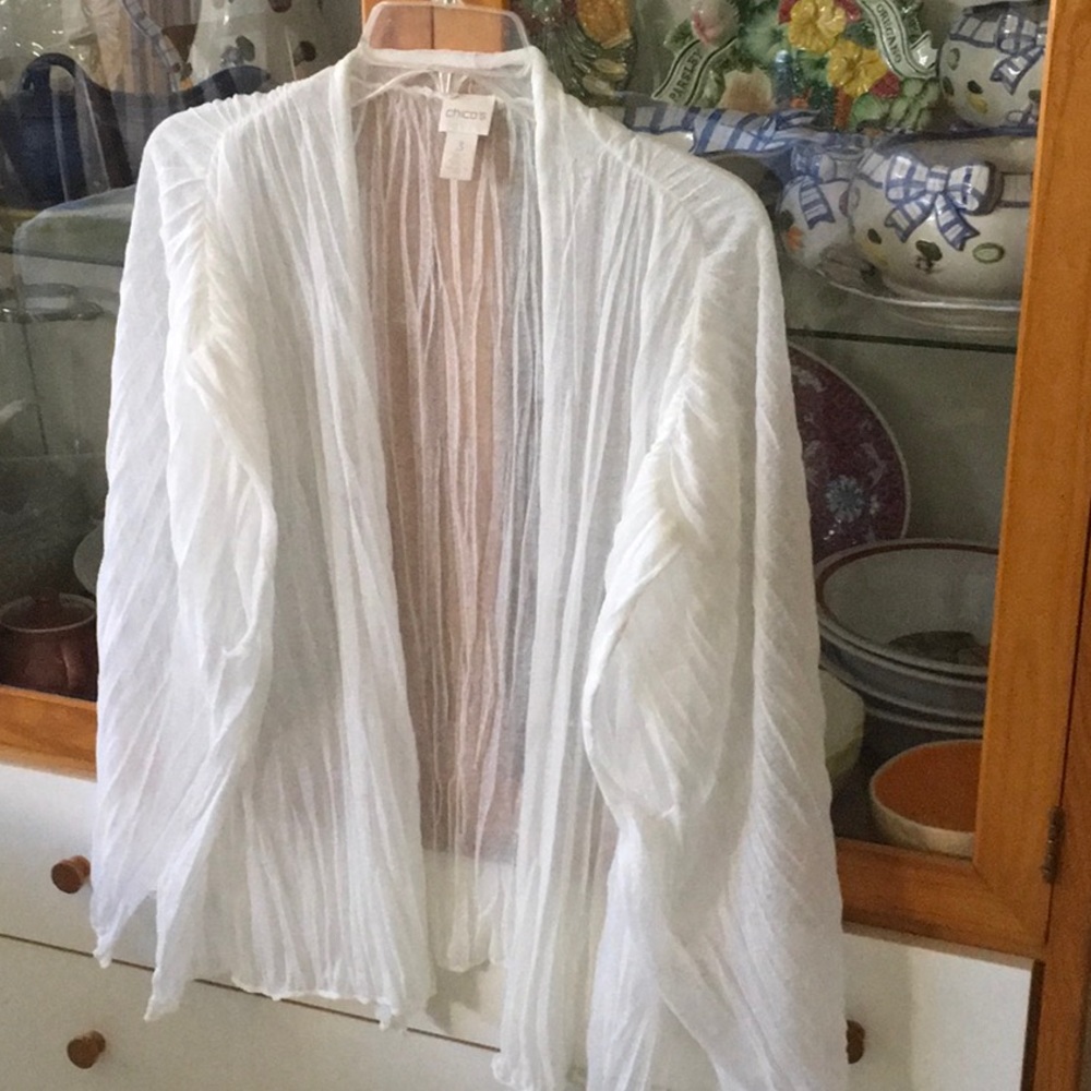Sleeveless, see through jacket.  Loose fit. Dropped shoulders.